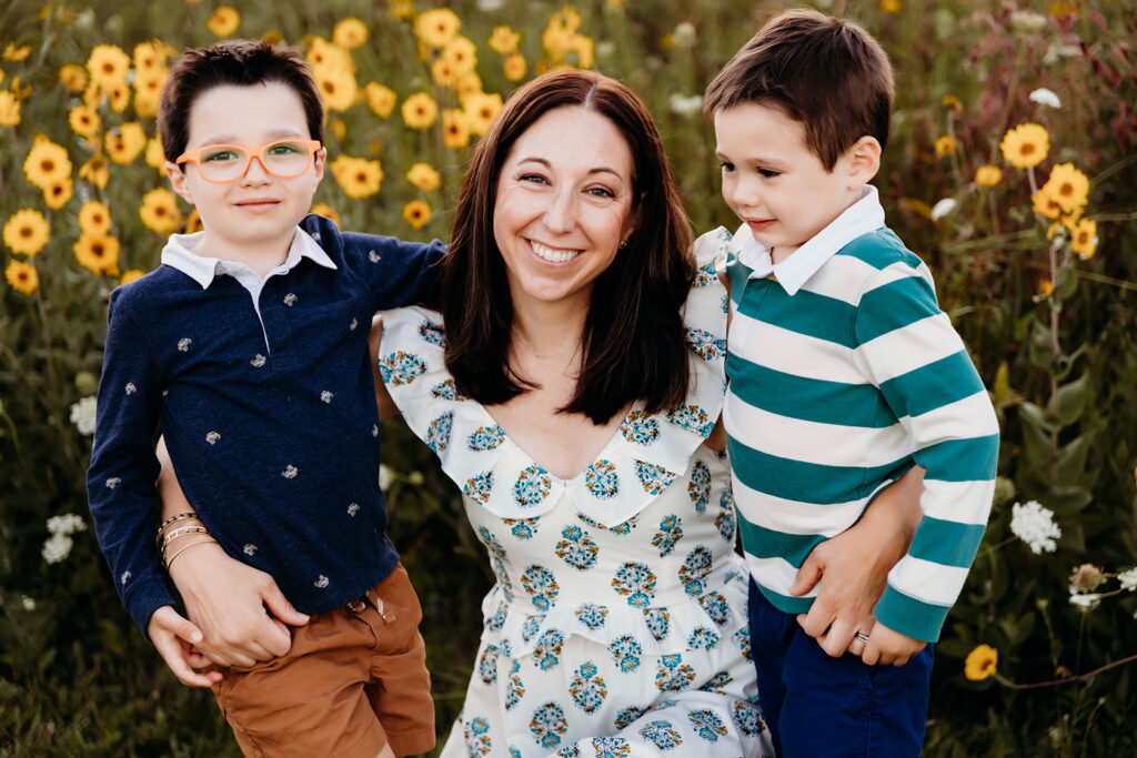 A mom in the middle of her 5-year-old twin boys smiling. Indianapolis photographer