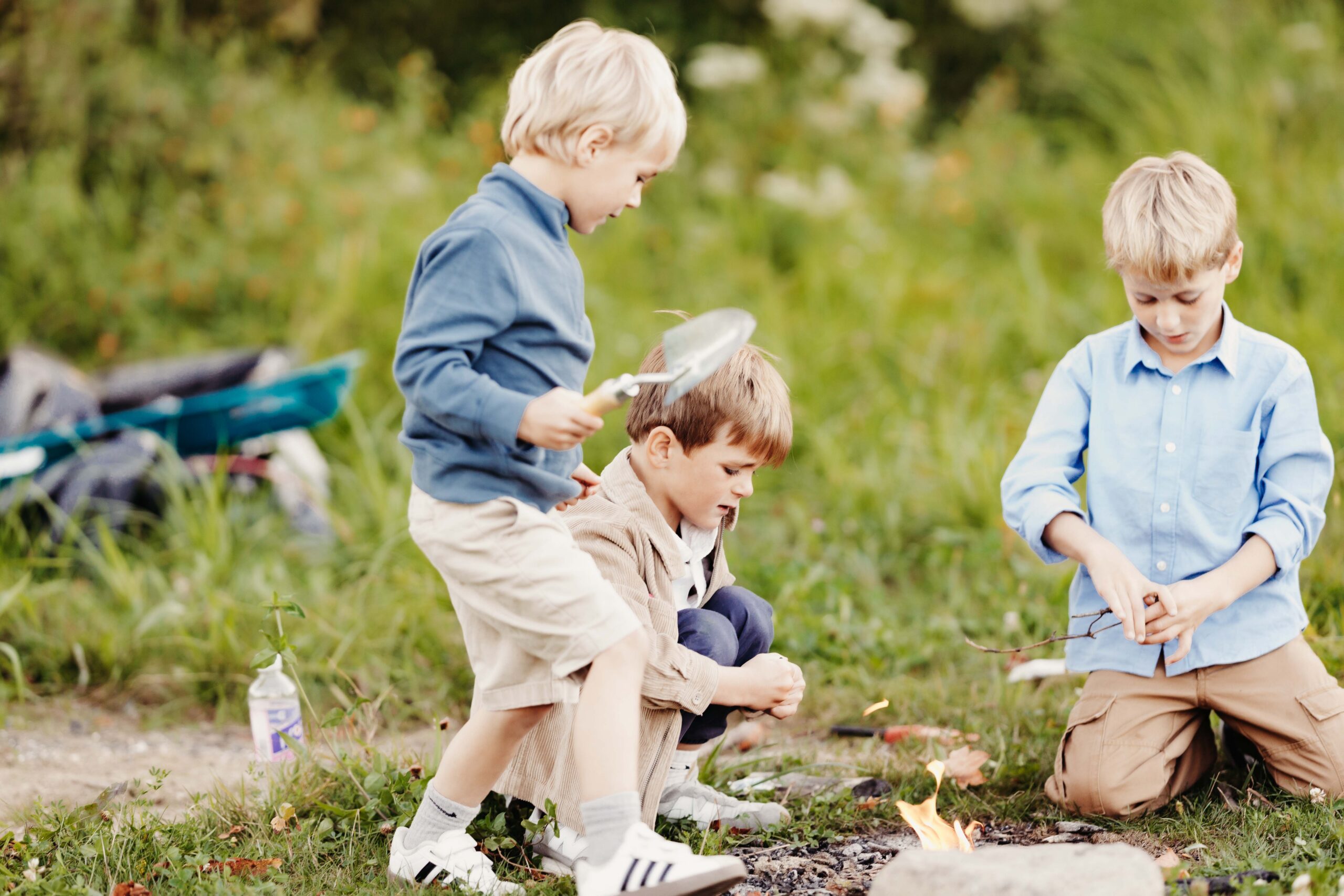 Little boys playing outside with dirt and sticks. Carmel family photographer.