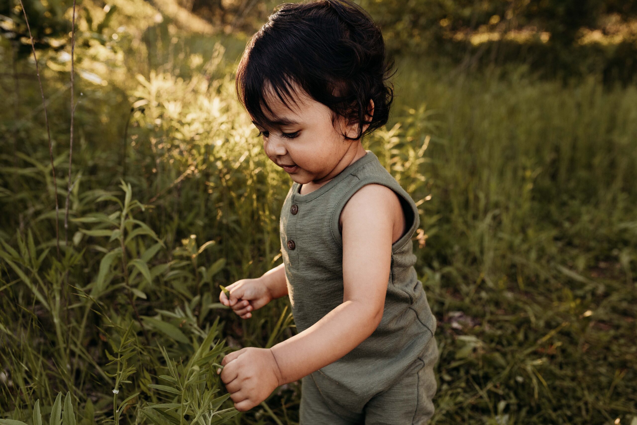 Little one looking at flowers. Noblesville Family Photographer