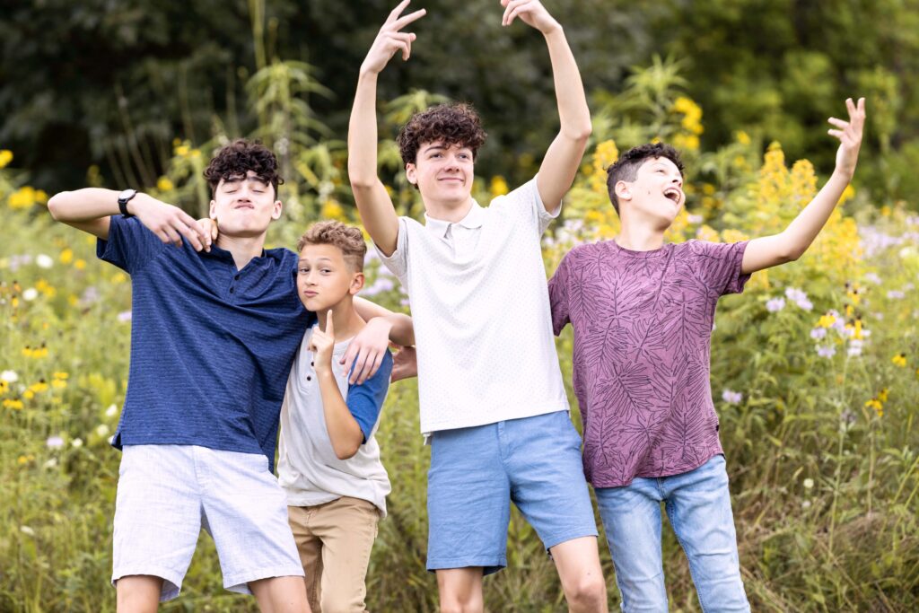 4 boys, 10-18 years old, being silly for the camera. Indianapolis family photographer. 

